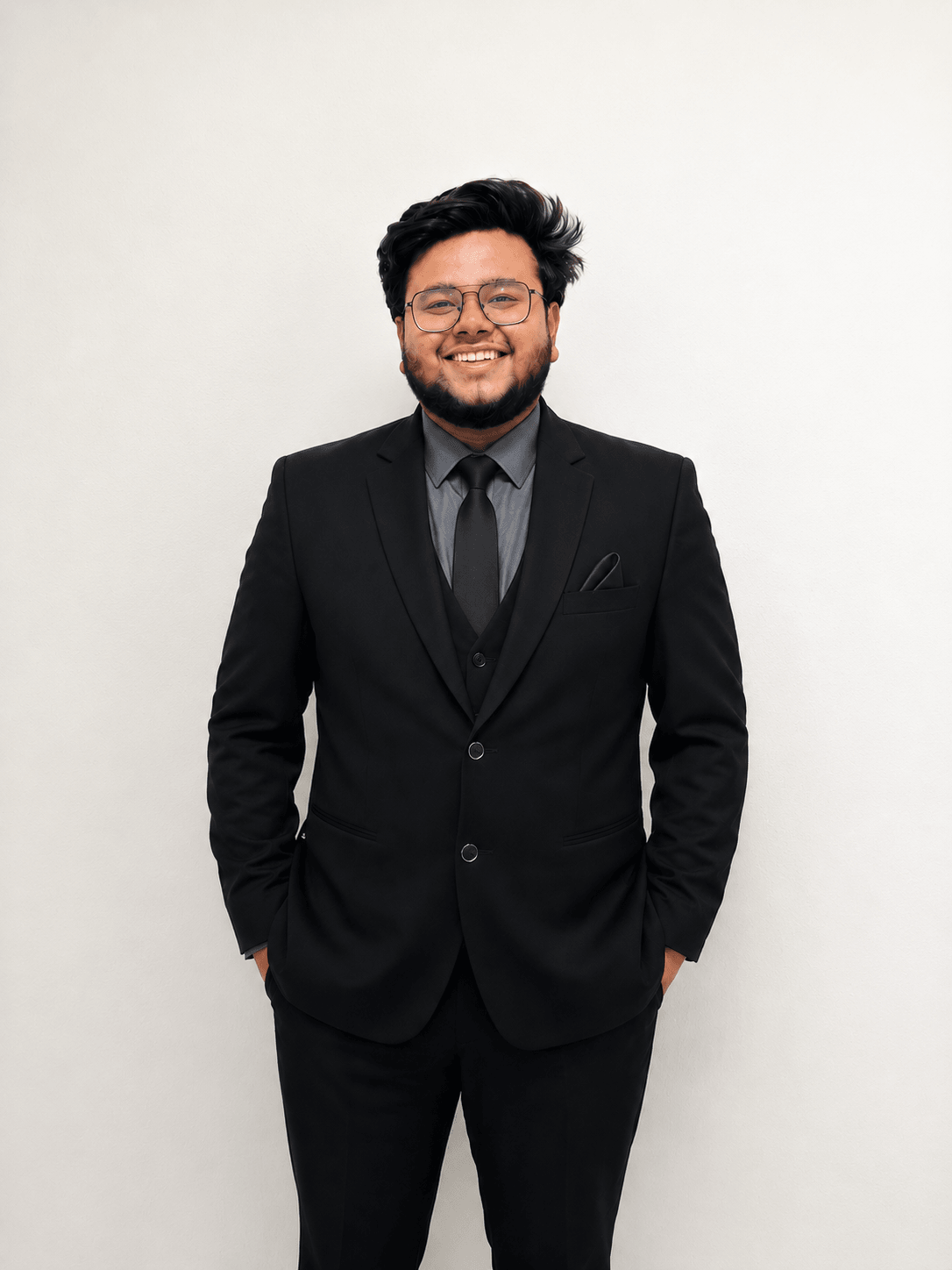 Mehul Gupta, standing in a black suit against a plain wall.